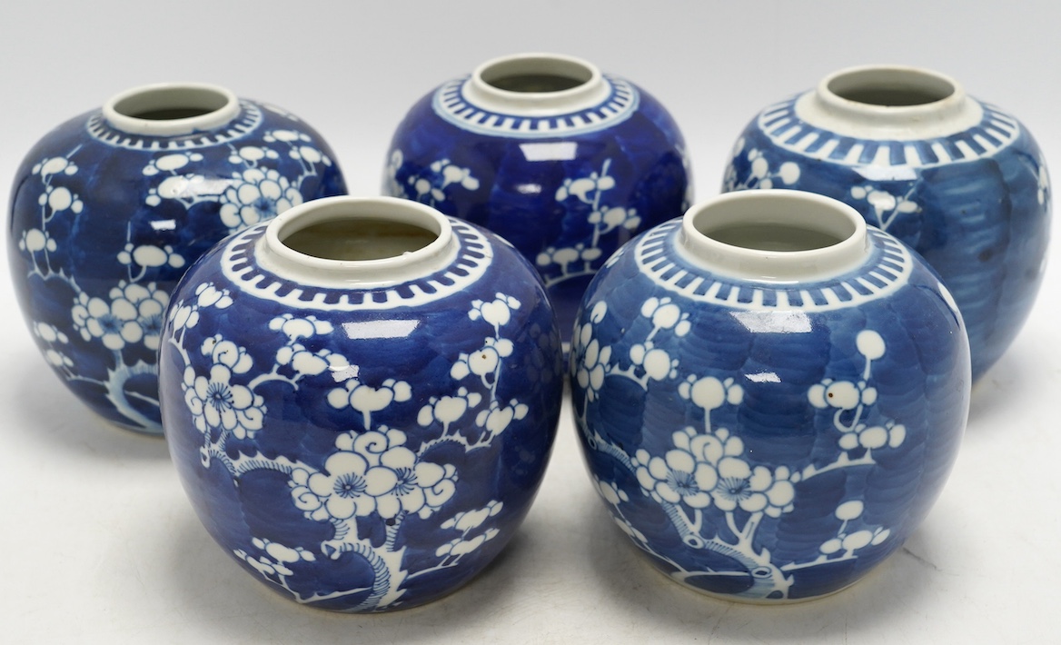 Five Chinese blue and white prunus jars, without covers, early 20th century, tallest 13cm high. Condition - one jar is chipped around the top, another has a large firing fault, the other two good
